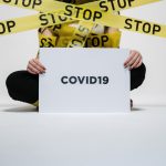 person holding covid sign