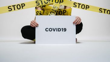 person holding covid sign